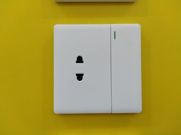 elektirik yuvası: Divarda quraşdırılmış bu ağ elektrik rozetkası və açarı eyni vaxtda