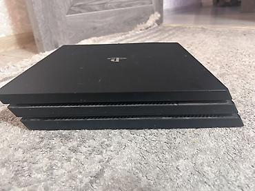 пл: Игровая приставка Sony PlayStation 4 Pro. Модель в фирменном черном — 1
