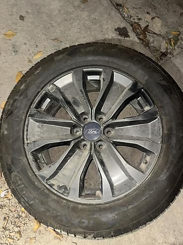 Дөңгөлөктөр монтажда: Диск Ford с шиной - Оригинальный литой диск Ford, 10‑спицевый, под 5 — 1
