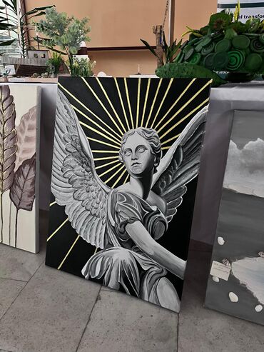 starex qara qarayev фото: Qanadlı mələyin təsviri olan qara rəngli rəsm əsəri. Qızılı rəngdə