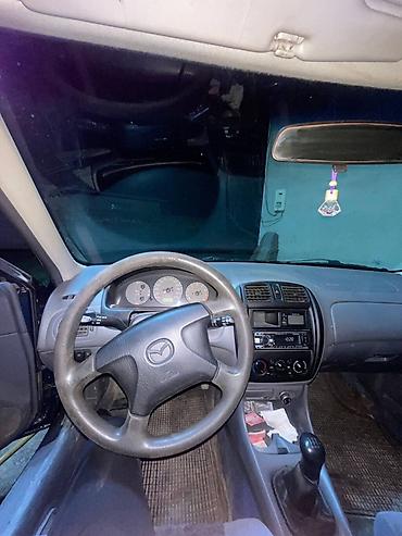 червяк 124: Mazda 323: 1999 г., 1.5 л, Механика, Седан — 6