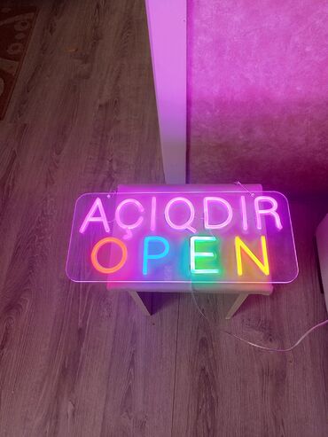 Ev saatları: Bu, iki dilli "AÇIQDIR" və "OPEN" sözlərini əks etdirən neon işıqlı