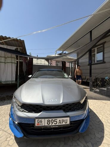 киа к5 2021 расширительный бочка: Автомобиль Kia K5 в сером цвете с акцентами синего цвета на бамперах и