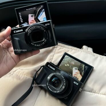 домашняя камера: Компактная цифровая камера Canon G7X в черном корпусе. Оснащена
