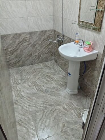 Ağ rəngdə və mavi detallarla bəzədilmiş bu hamam dolabı lavabo ilə