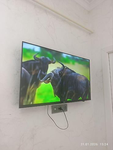 Телевизоры: Телевизор KIVI (надпись на рамке) с тонкими рамками, настенное — 3