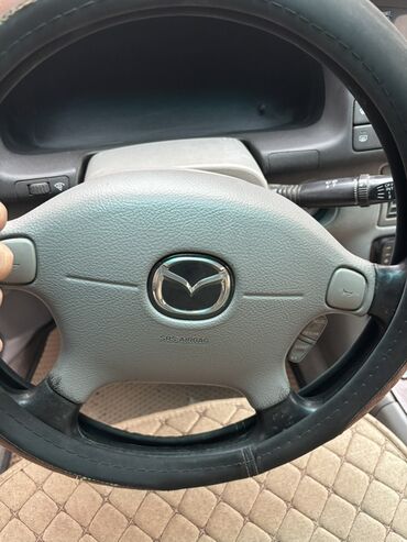 операционные системы электронный ключ: Mazda — легковой седан, салон бежево‑серого тона. Основные