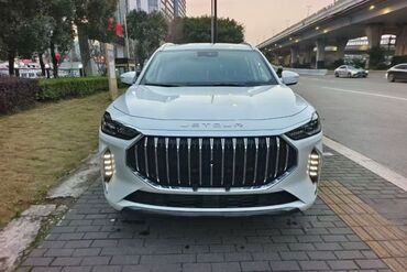 руль для скутера: Белый кроссовер марки Jetour. Автомобиль имеет большую решетку