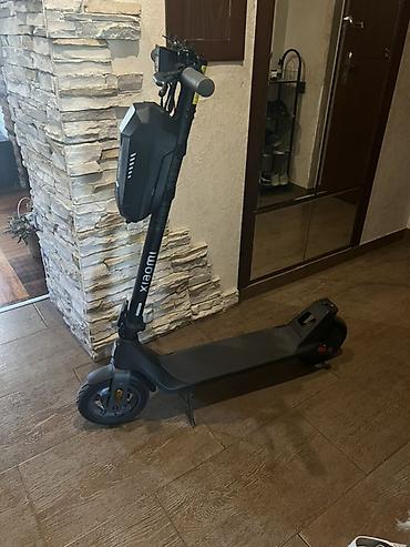 Xiaomi elektrik skuter. Şəkillərdə qara rəngli, minimalist dizayna