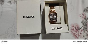 takema saat: Casio qol saatı – qızılı rəngli, kvadrat/örtülü düzbucaqlı korpuslu — 1