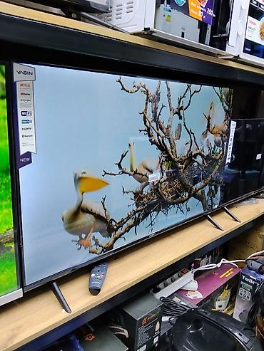 Смарт‑телевизор YASIN, диагональ около 55–65". Узкие рамки, две