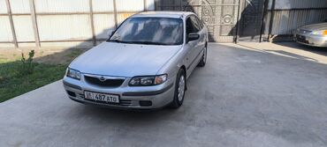 авто рынык бишкек: Серебристый седан Mazda 626 с четырехдверным кузовом, выполненный в