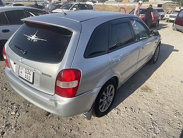 цифры наклейки: Mazda Familia: 2001 г., 2 л, Механика, Бензин, Универсал — 2
