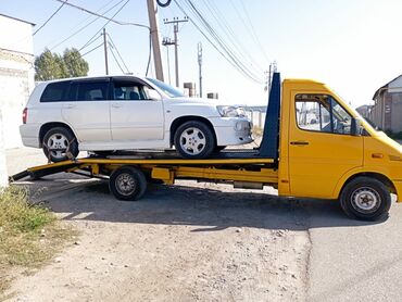 в токмоке: С частичной погрузкой, С лебедкой, Со сдвижной платформой