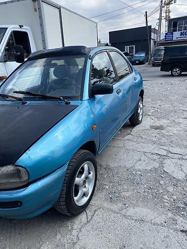 фара мазда 121: Mazda 121: 1991 г., Седан — 2
