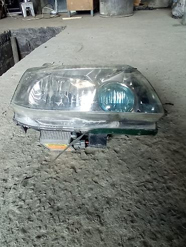 reflektör mont: Nissan farası – sol ön (Hella/Nikko nişanlamalı). Orijinal far — 1