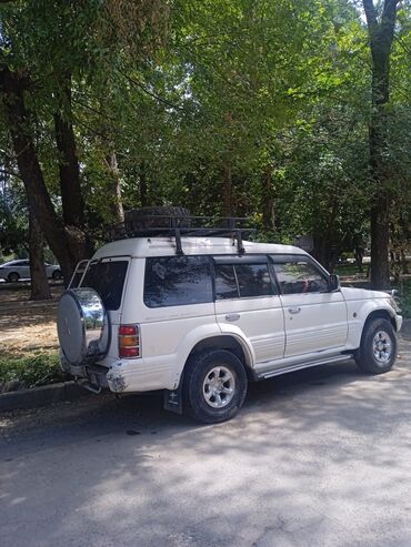 двигатель митсубиси спейс вагон: Белый внедорожник Mitsubishi Pajero, оснащенный багажником на крыше с