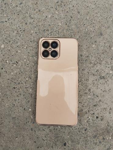 nokia 2720 fold: Smartfon – qızılı rəngdə korpus, iri tam ekranlı ön panel. telfon — 2