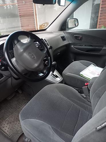 l200 disk: Hyundai Tucson, qara rəng, şəhər və uzun yol üçün rahat SUV. Texniki — 2