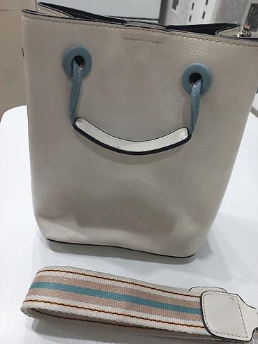 Женская сумка-ведро (bucket bag) из фактурного кожаного материала в