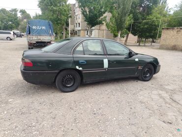 Opel: Tünd yaşıl rəngdə olan bu Opel Omega sedanı, rahat və etibarlı bir lalafo.az -da Opel: Tünd yaşıl rəngdə olan bu Opel Omega sedanı, rahat və etibarlı bir