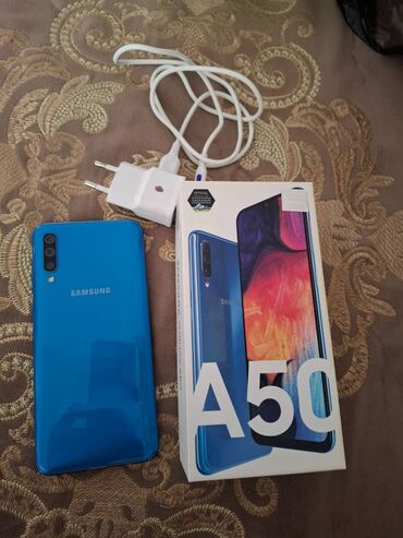 купить телефон бесплатно: Samsung Galaxy A50, 64 ГБ, цвет - Голубой, Две SIM карты