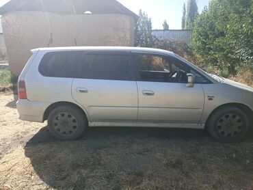 домкрат для машины цена: Серебристый минивэн Honda Odyssey с затемненными стеклами. Автомобиль