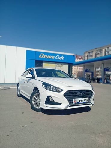 hyundai sonata гибрид: Белый седан Hyundai Sonata с элегантным дизайном. Автомобиль оснащен