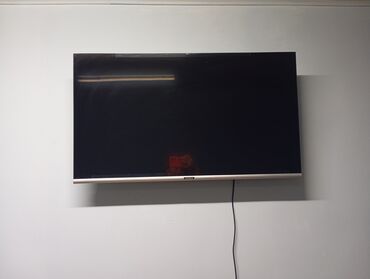 наклейка на ноутбук: Телевизор Thomson LED на настенном креплении. - Диагональ