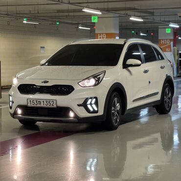 электромобиль neta: Белый гибридный кроссовер Kia Niro. Автомобиль оснащен светодиодными