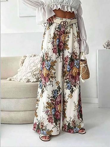 sat raketa: Široke pantalone za punije dame sa floralnim printom. - Model: široke — 1