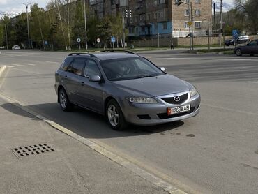 машина бесплатно: Универсал Mazda 6 серого цвета. Автомобиль оснащен рейлингами на крыше