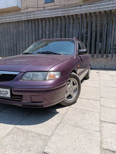 диско 15: Mazda 626 фиолетового цвета, универсал. Автомобиль оснащен рейлингами