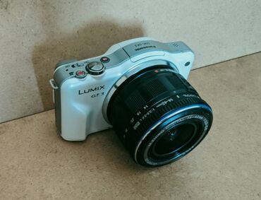 цифровой аппарат: Panasonic LUMIX GF3 белого цвета. Оснащена объективом Olympus M.ZUIKO