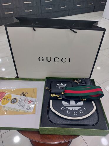 Gucci canta.Icerisinde cuzdan ve brulokda var.Yenidir satis ucun