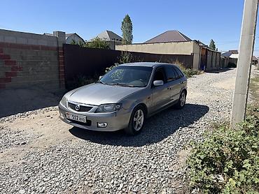 руль левый: Mazda 323: 2002 г., Механика, Бензин, Хэтчбэк — 1