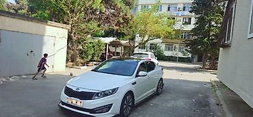 kia carnival: Kia Optima – ağ rəng, sedan, idman üslublu eksteryer paketli. Əsas — 1