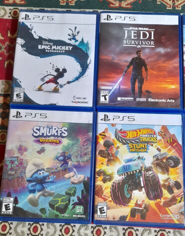 Oyun diskləri və kartricləri: Müxtəlif PlayStation oyunları. Buraya "Star Wars Jedi: Survivor", "Hot