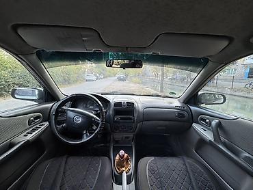 байд машина: Mazda Familia: 2002 г., 1.6 л, Кол менен иштөөчү, Бензин, Хетчбек — 9