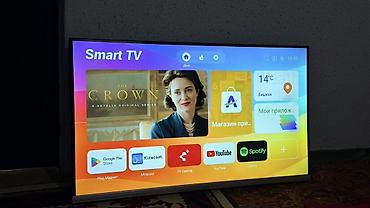 Телевизоры: Телевизор Smart TV, диагональ около 40–43". Тонкие рамки, нижняя — 4