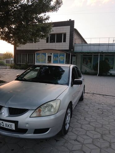 шины бишкек дордой: Серебристый седан Mitsubishi Lancer с четырьмя дверями, оснащенный