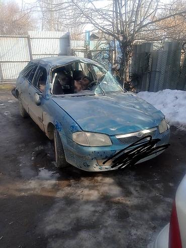 platform ok: Mazda 323F хэтчбек, синего цвета. Автомобиль после сильных — 1