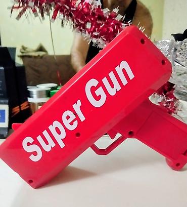 Pul atıcı oyuncaq tapança, parlaq qırmızı rəngdə və üzərində “Super