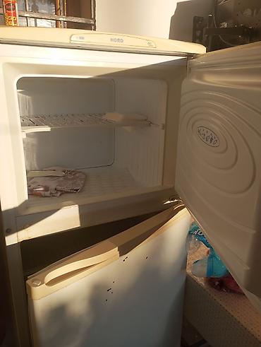 ev ucun soyuducular: Nord brendinin ikiqapılı soyuducusu, üst hissəsində dondurucu kamerası — 1