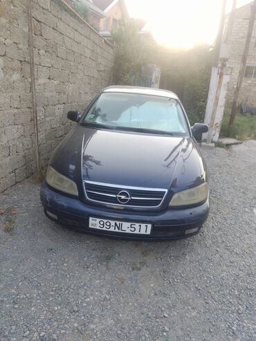 авто под выкуп бишкек: Tünd göy rəngli dördqapılı Opel Omega avtomobili. Avtomobilin ön