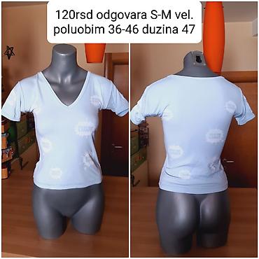 t: Ženska majica kratkih rukava, svetloplave boje, sa V-izrezom. Na — 1