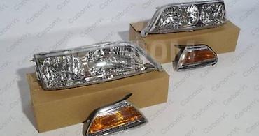 100: Комплект передних фар Toyota 2000 г., Новый, Аналог — 2