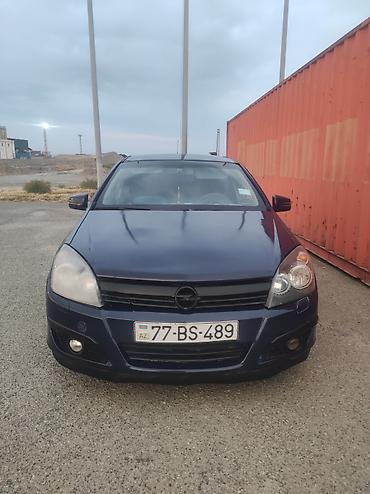 opel astra satışı: Opel Astra hetçbek avtomobil. Tünd göy rəngdə kuzova malikdir. 5 — 2