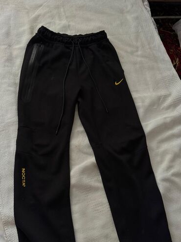 одежда для танцев: Спортивные брюки Nike Nocta в черном цвете с золотистыми деталями
