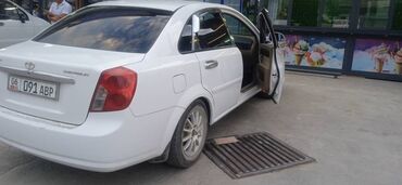 ласетти жентра: Белый седан Chevrolet Lacetti, оснащенный литыми дисками. Автомобиль